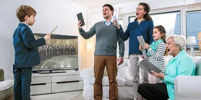 A family practices songs during Family Worship