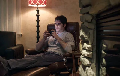 A brother views questionable material on his phone late at night