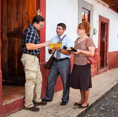 Two pioneers preach to a man