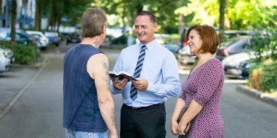 Joseph Ehrenbogen and his wife preach to a man