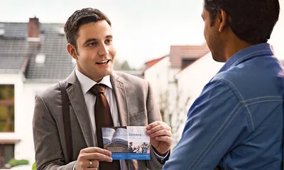 A brother offers a meeting invitation to a man