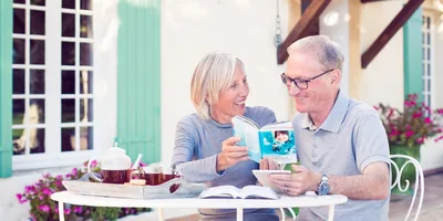 An older couple reads a ‘Young People Ask’ book together
