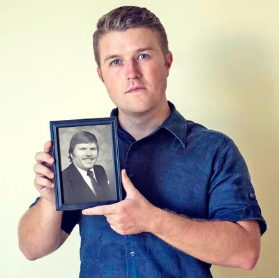 Derrick holds a picture of his father