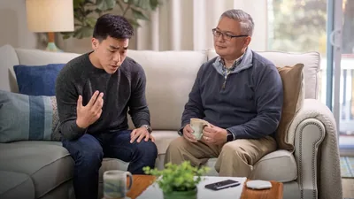 A younger brother expressing himself to a mature friend at his home.