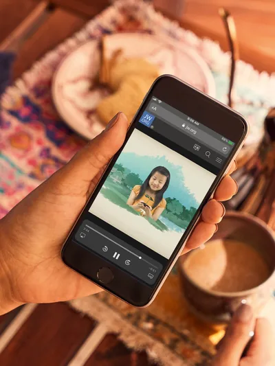 An informative Bible video playing on a cell phone.