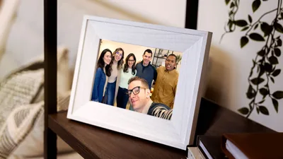 A framed photo of a group of smiling brothers and sisters.
