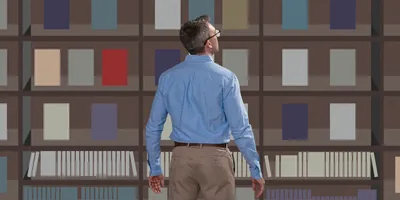 A man looks up at shelves full of books