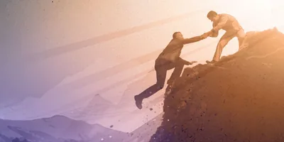 As a man starts to fall off a cliff, another man grabs his hand and pulls him to safety