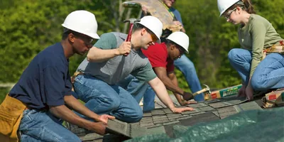 Brothers and sisters repairing a roof.