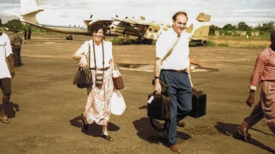 Paul and Anne walking on the tarmac after arriving at the Liberia airport.