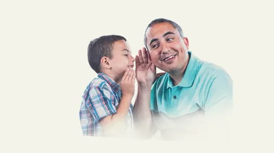 A father listening attentively to his young son.