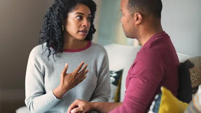 A husband patiently listening to his wife as she expresses herself.