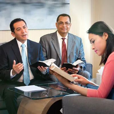 Two elders talk with a sister