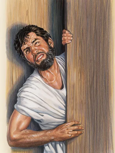A man exerts himself vigorously to get through a narrow door