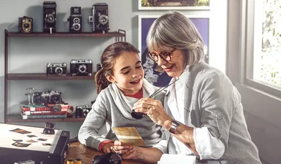 A woman shows a girl her old photos