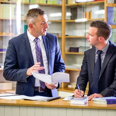Shane talks with a local Christian brother at a literature counter in a Kingdom Hall