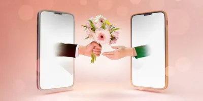 Two mobile devices with their screens facing each other. A man’s hand extends out of one screen with a bouquet of flowers, and out of the other screen, a woman’s hand reaches to accept them.