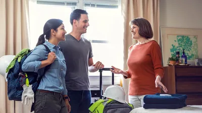 A sister in her home, showing a couple with construction gear their guest room.