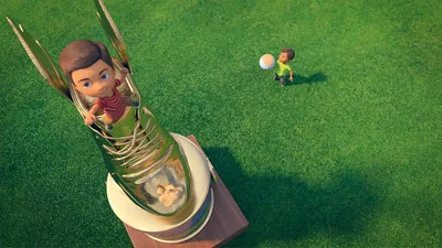 Caleb posing on top of a giant trophy while he brags to his friend who is standing on the ground below.