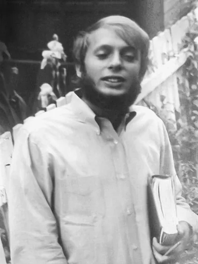 Martin, before becoming a Witness, wearing a beard and holding a Bible.