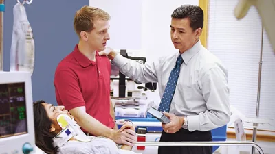 A brother using the Bible to provide comfort to a brother and his badly injured wife at a hospital.