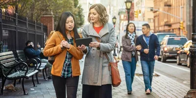 A sister witnessing to an Asian woman.