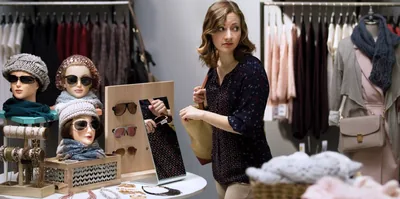 A woman steals sunglasses in a shop