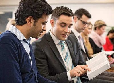 A brother shares his Bible with an interested man