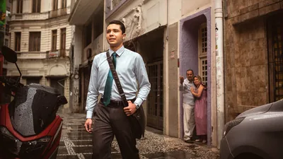 A young brother dressed for a congregation meeting, walking confidently while his parents yell at him from their doorstep.