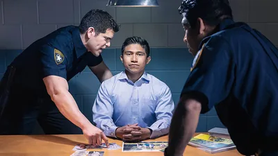 A brother remaining silent while police officers interrogate him.