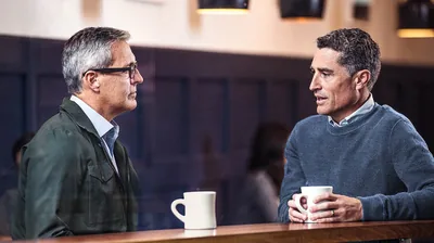 A brother carefully listening as another brother expresses himself.