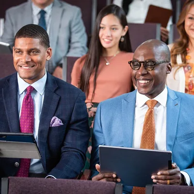 The man is attending a meeting at a Kingdom Hall.