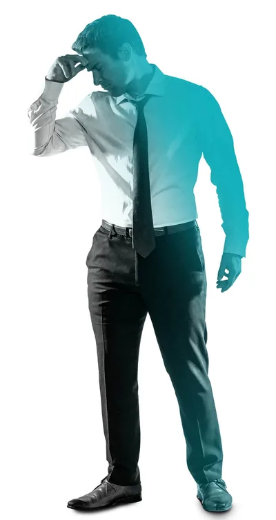 A man, holding his hand to his forehead, feeling the effects of stress.