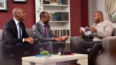 Two elders visiting an inactive brother and inviting him to the Memorial.