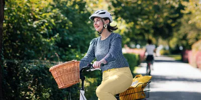 A happy woman riding a bicycle.