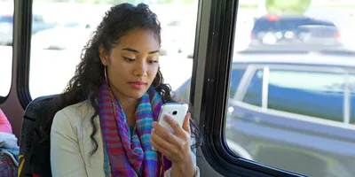 A woman looks at her electronic device