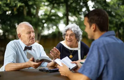 René and Lydie discussing the Bible with a man.