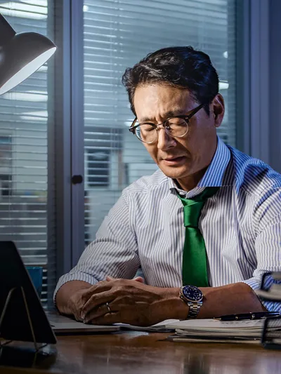 A businessman at his workplace praying.