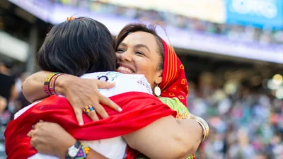 Two sisters hugging each other at a convention.
