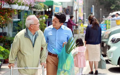 A younger brother helps an older brother with shopping
