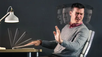 A brother turning away in disgust from his laptop computer and quickly closing it.