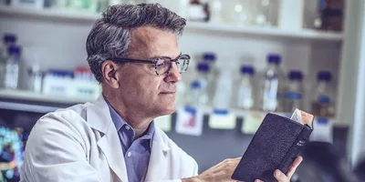 One of the scientists referred to earlier reads the Bible