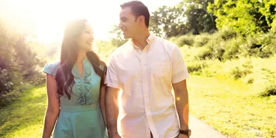 A scene from the video “Your Family Can Be Happy.” A happy couple hold hands and walk down a path.