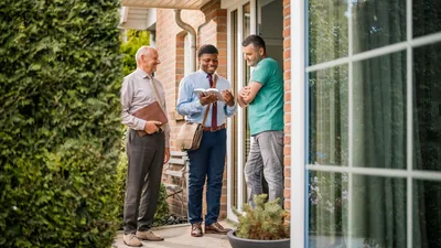 One of the newly baptized brothers shown in the previous image, sharing a scripture with a man he meets in the house-to-house ministry.