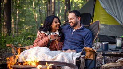 The couple from the preceding image, now married and enjoying time together at a campsite.
