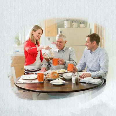 A young couple shares a meal with an older brother