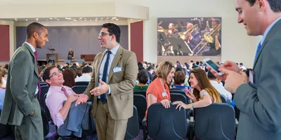 Some are distracted during the musical prelude that begins a convention session