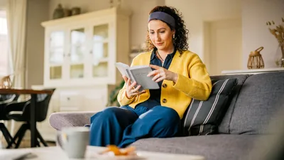 One of the newly baptized sisters shown in the previous image, reading the Bible in her home.
