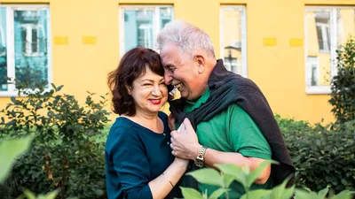A happy older couple embracing.
