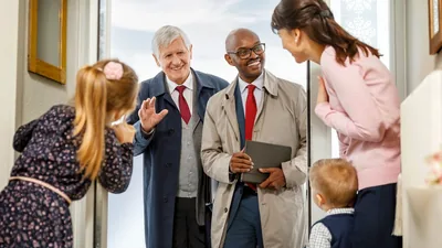 Two elders visiting a sister and her two children at their home.